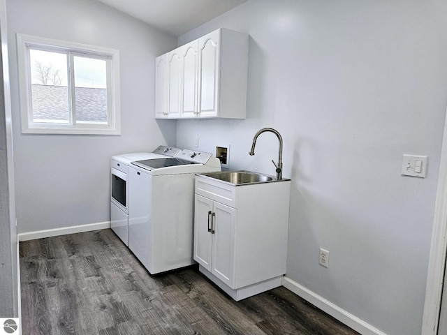 laundry area featuring washer and dryer, cabinet space, baseboards, and a sink