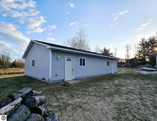 back of house with a lawn