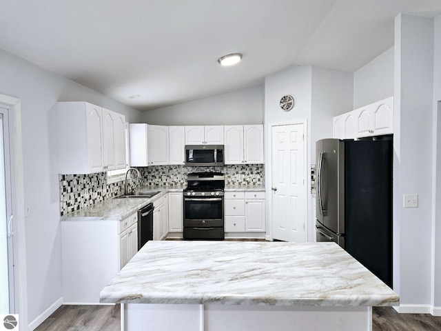 kitchen with a sink, tasteful backsplash, appliances with stainless steel finishes, and dark wood finished floors