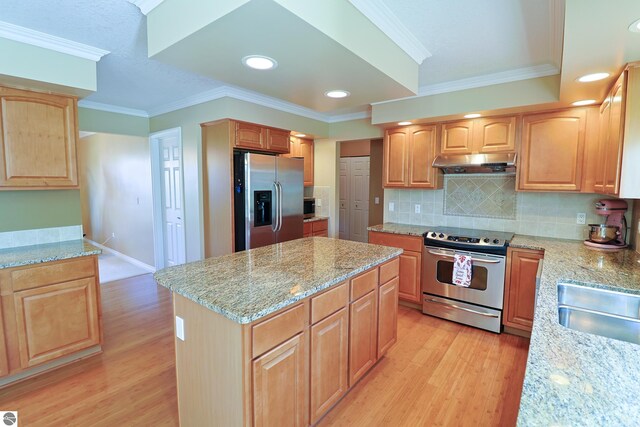 kitchen with light stone countertops, ornamental molding, stainless steel appliances, exhaust hood, and light wood-type flooring