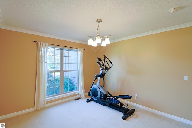 exercise room with a notable chandelier, carpet, baseboards, and ornamental molding