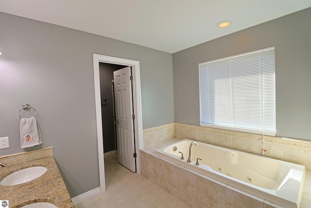 full bathroom with a sink, a tub with jets, tile patterned floors, and double vanity