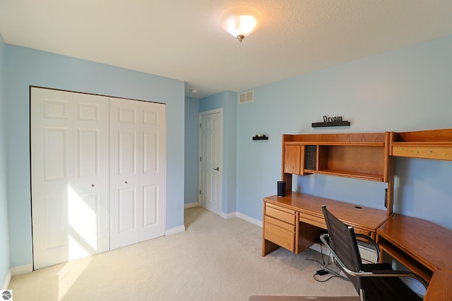 home office featuring visible vents, baseboards, and light colored carpet