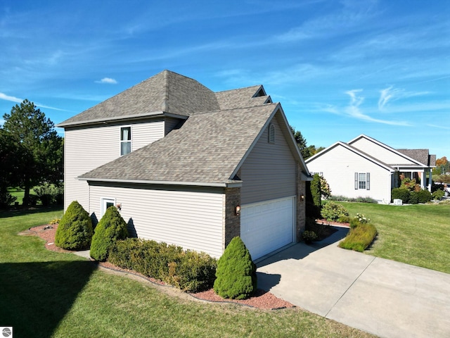 view of home's exterior featuring a lawn, roof with shingles, concrete driveway, and an attached garage