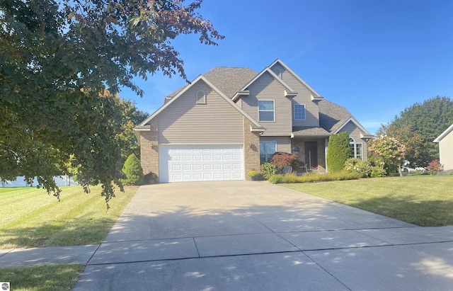 traditional-style house featuring a front yard, a garage, brick siding, and driveway