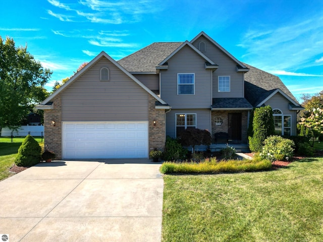 view of front of home featuring a front yard, driveway, roof with shingles, an attached garage, and brick siding