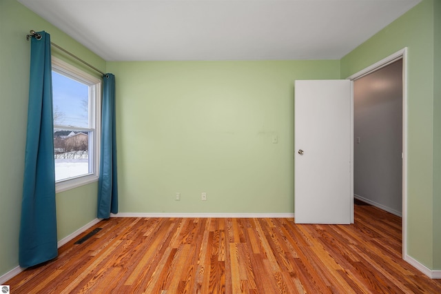 interior space featuring visible vents, baseboards, and wood finished floors