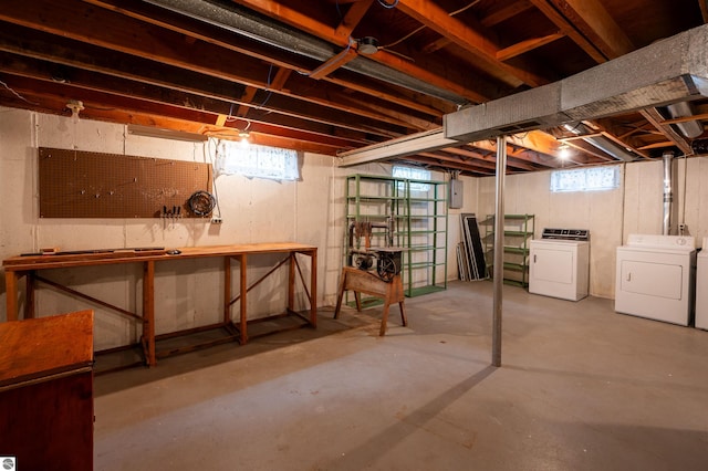 below grade area featuring electric panel, a workshop area, and independent washer and dryer