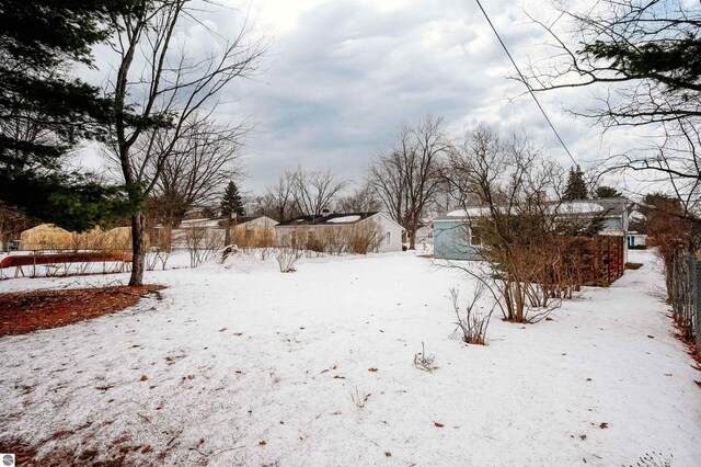 snowy yard with fence