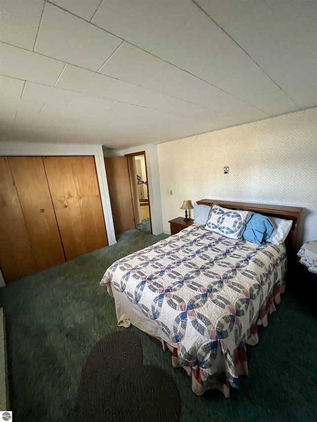 carpeted bedroom with wallpapered walls