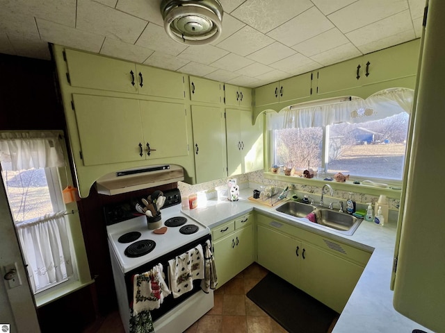 kitchen featuring a sink, white appliances, a wealth of natural light, and light countertops