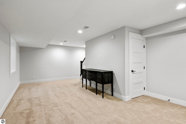 finished below grade area featuring recessed lighting, visible vents, carpet flooring, and baseboards