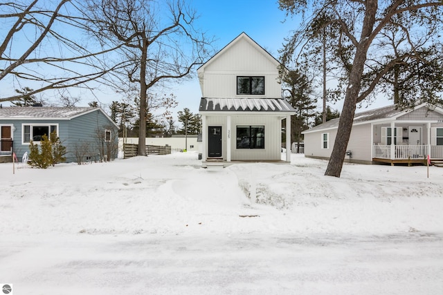 modern inspired farmhouse featuring metal roof, board and batten siding, and a standing seam roof