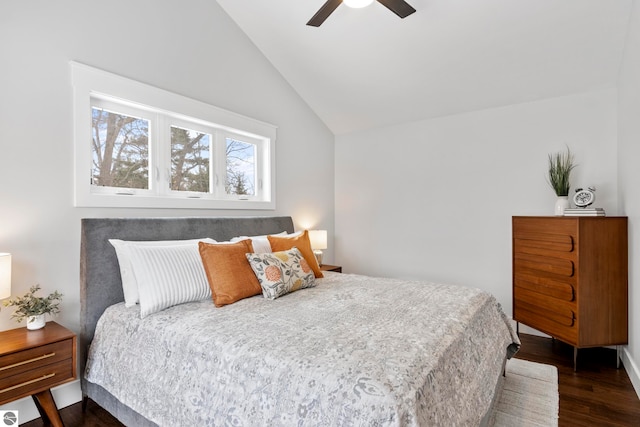 bedroom featuring lofted ceiling, dark wood-type flooring, and ceiling fan