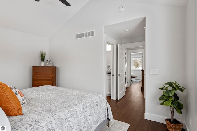 bedroom featuring a ceiling fan, baseboards, visible vents, vaulted ceiling, and dark wood-type flooring