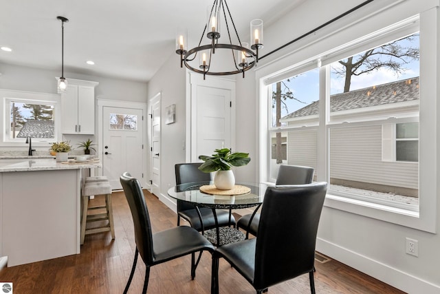 dining space with dark wood finished floors, recessed lighting, baseboards, and a wealth of natural light