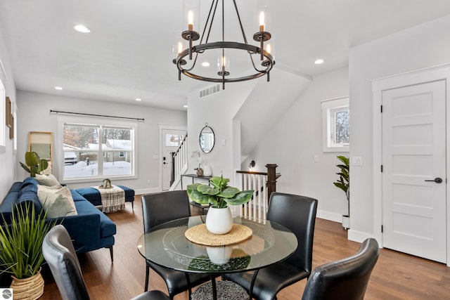 dining area featuring visible vents, baseboards, stairs, recessed lighting, and wood finished floors