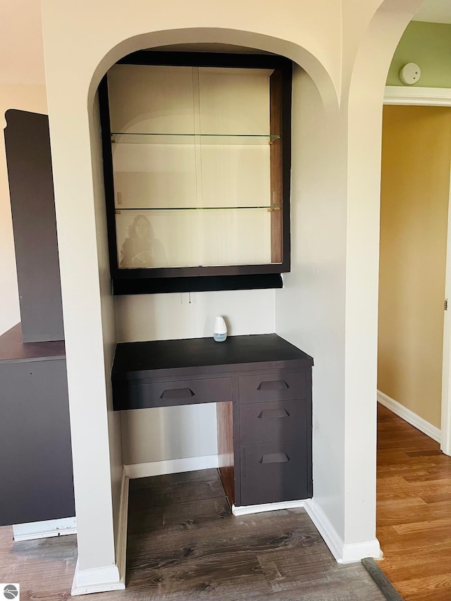 interior space with baseboards and wood finished floors