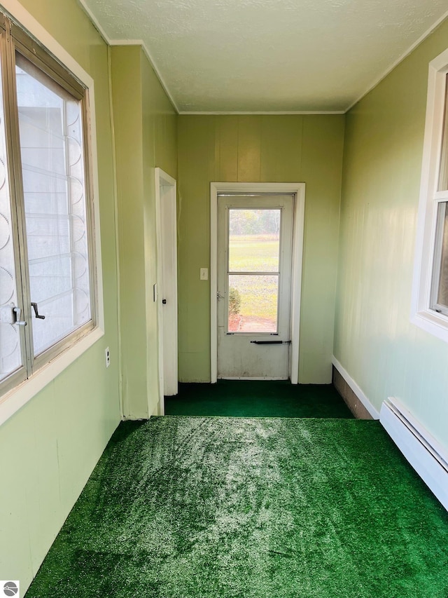 doorway with carpet flooring and a baseboard radiator