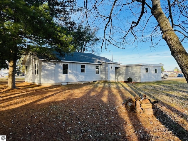 rear view of property featuring driveway