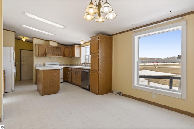 kitchen featuring white appliances, a kitchen island, lofted ceiling, light countertops, and brown cabinets