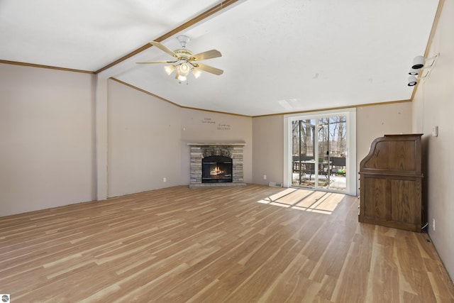 unfurnished living room featuring light wood finished floors, a fireplace, and ornamental molding