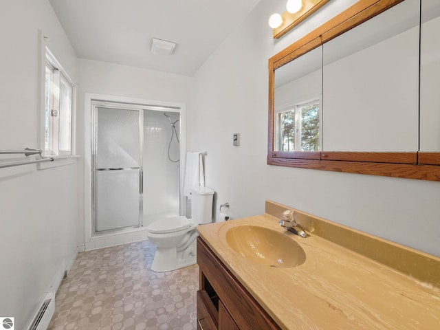 full bathroom featuring a shower stall, baseboards, toilet, vanity, and a baseboard radiator