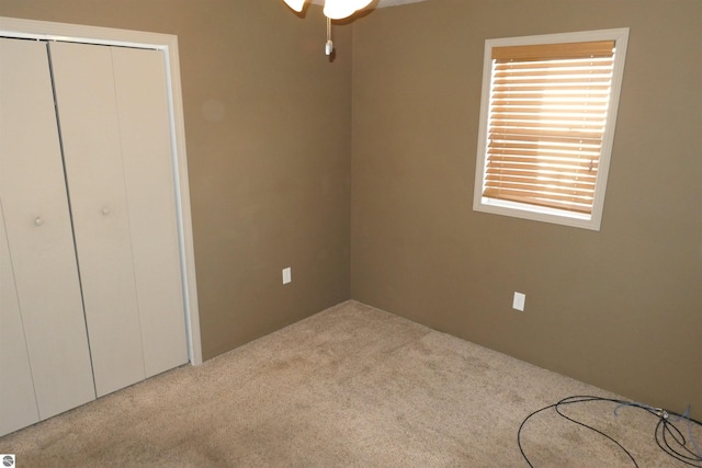 unfurnished bedroom with a closet and carpet flooring