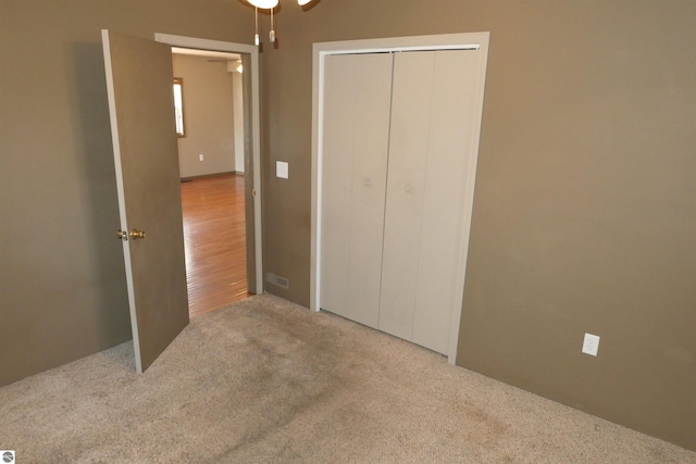 unfurnished bedroom with a closet and carpet