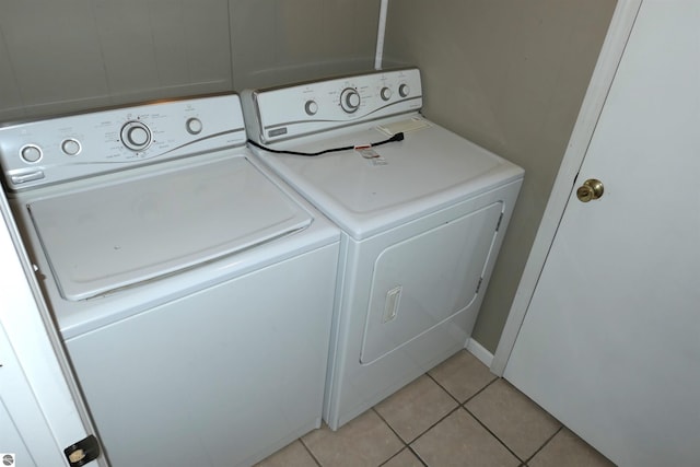 laundry area with laundry area, light tile patterned floors, and independent washer and dryer