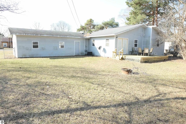 rear view of property featuring a yard, central AC unit, and a deck