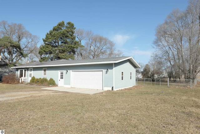 exterior space with a lawn, driveway, and fence