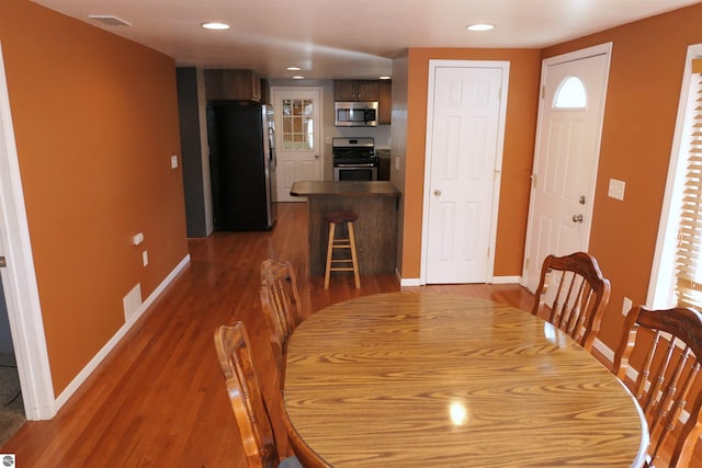 dining area featuring visible vents, recessed lighting, baseboards, and wood finished floors