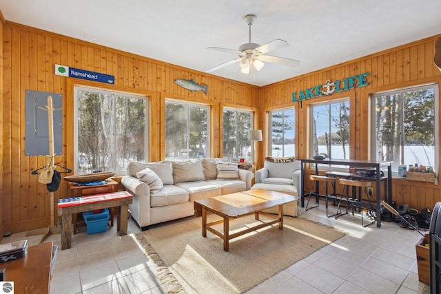 sunroom / solarium with a healthy amount of sunlight and a ceiling fan