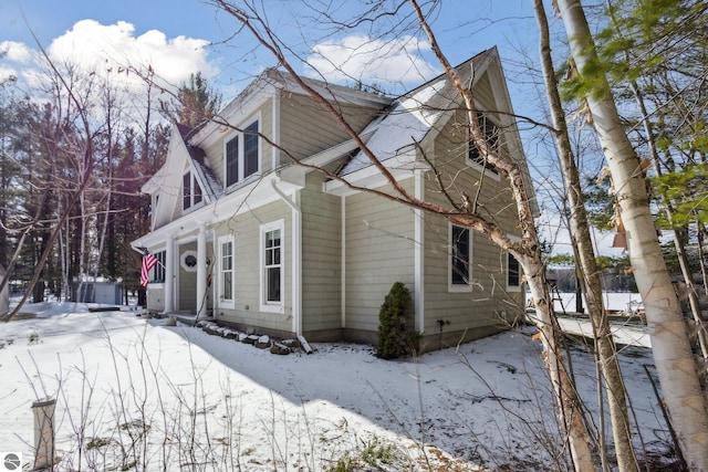 view of snowy exterior featuring fence