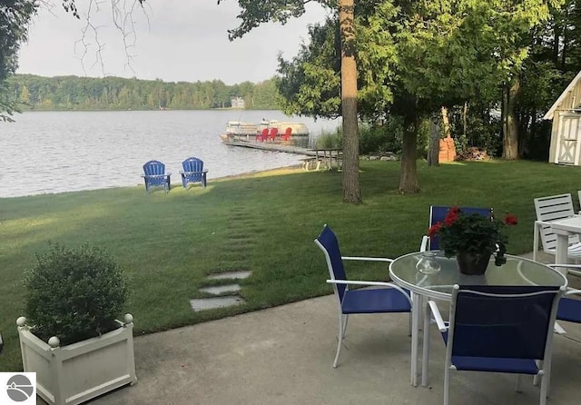 view of yard with a water view and a patio