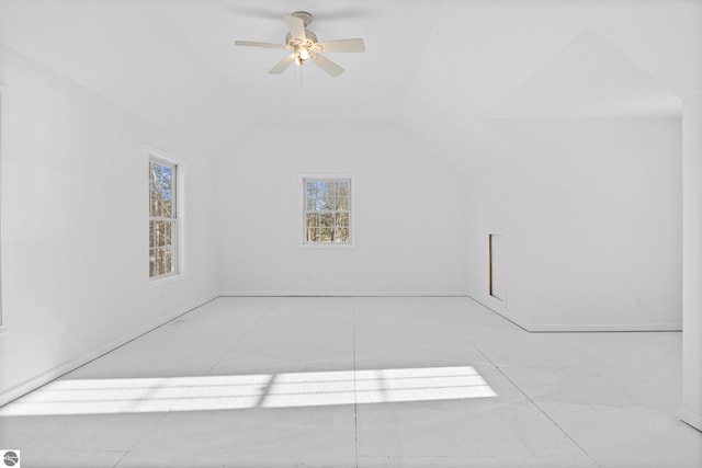 spare room featuring vaulted ceiling and ceiling fan