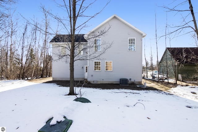 snow covered property featuring central air condition unit