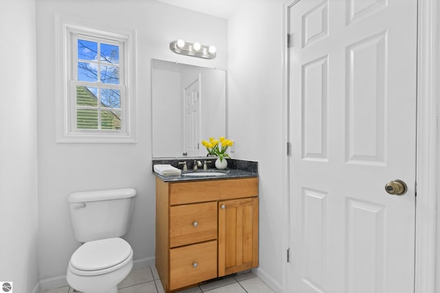 bathroom featuring tile patterned floors, baseboards, toilet, and vanity