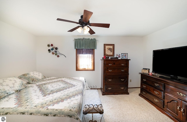 bedroom with baseboards, light colored carpet, and ceiling fan