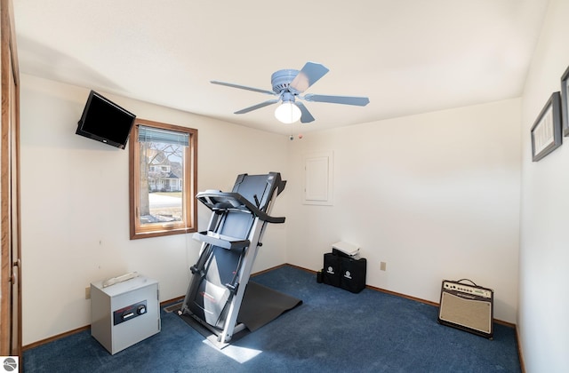 workout area featuring baseboards, carpet floors, and a ceiling fan