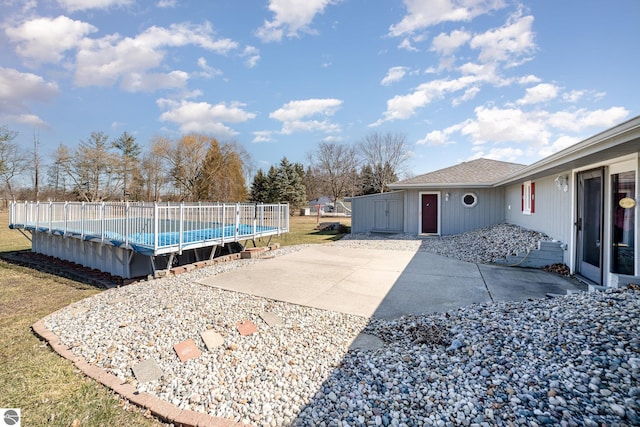 exterior space featuring a patio area and a covered pool