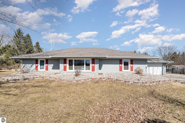 single story home with a front lawn, concrete driveway, and a shingled roof