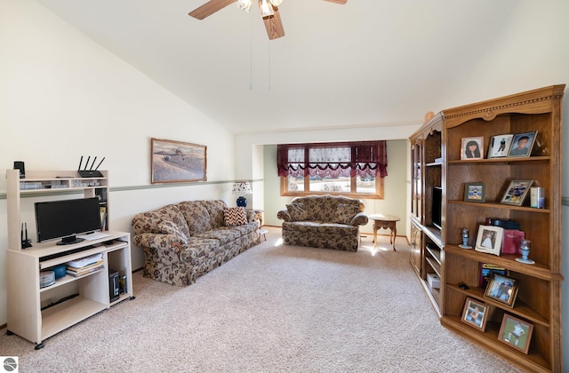 carpeted living area with a ceiling fan and lofted ceiling