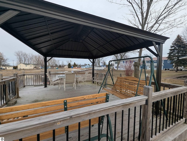 deck with a gazebo and outdoor dining area