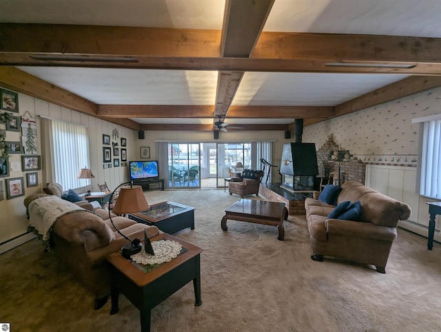 carpeted living area with a ceiling fan, wallpapered walls, beam ceiling, a wood stove, and a baseboard heating unit