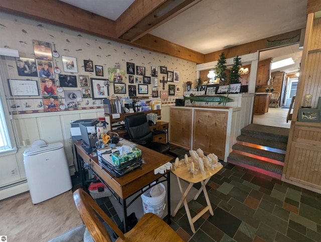 office area featuring a wainscoted wall, a baseboard radiator, wallpapered walls, beamed ceiling, and a decorative wall