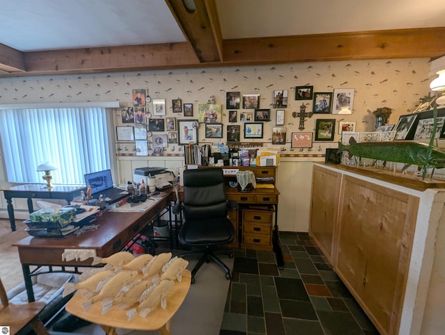 office area featuring wallpapered walls, beam ceiling, baseboard heating, wainscoting, and stone finish floor