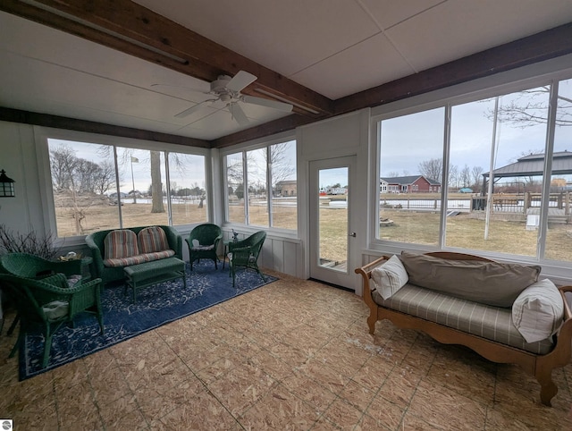 sunroom featuring beamed ceiling and ceiling fan