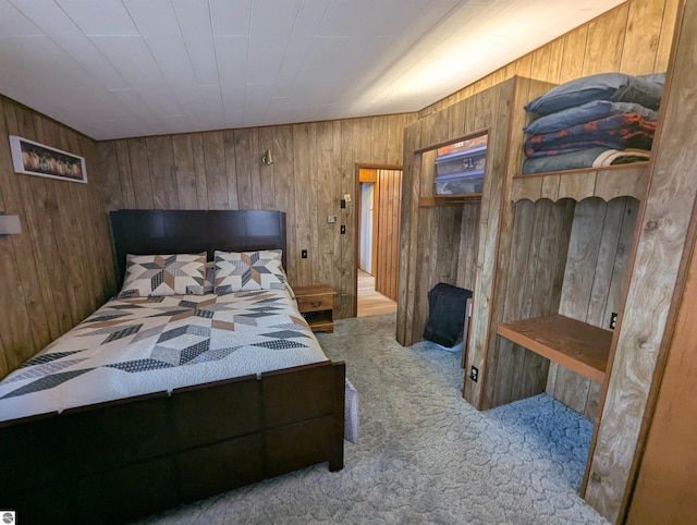 carpeted bedroom with wood walls